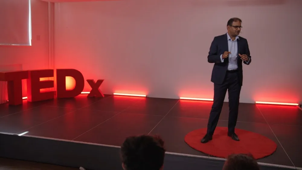Mithun A. Sridharan on stage at TEDxKarlshochschule International University